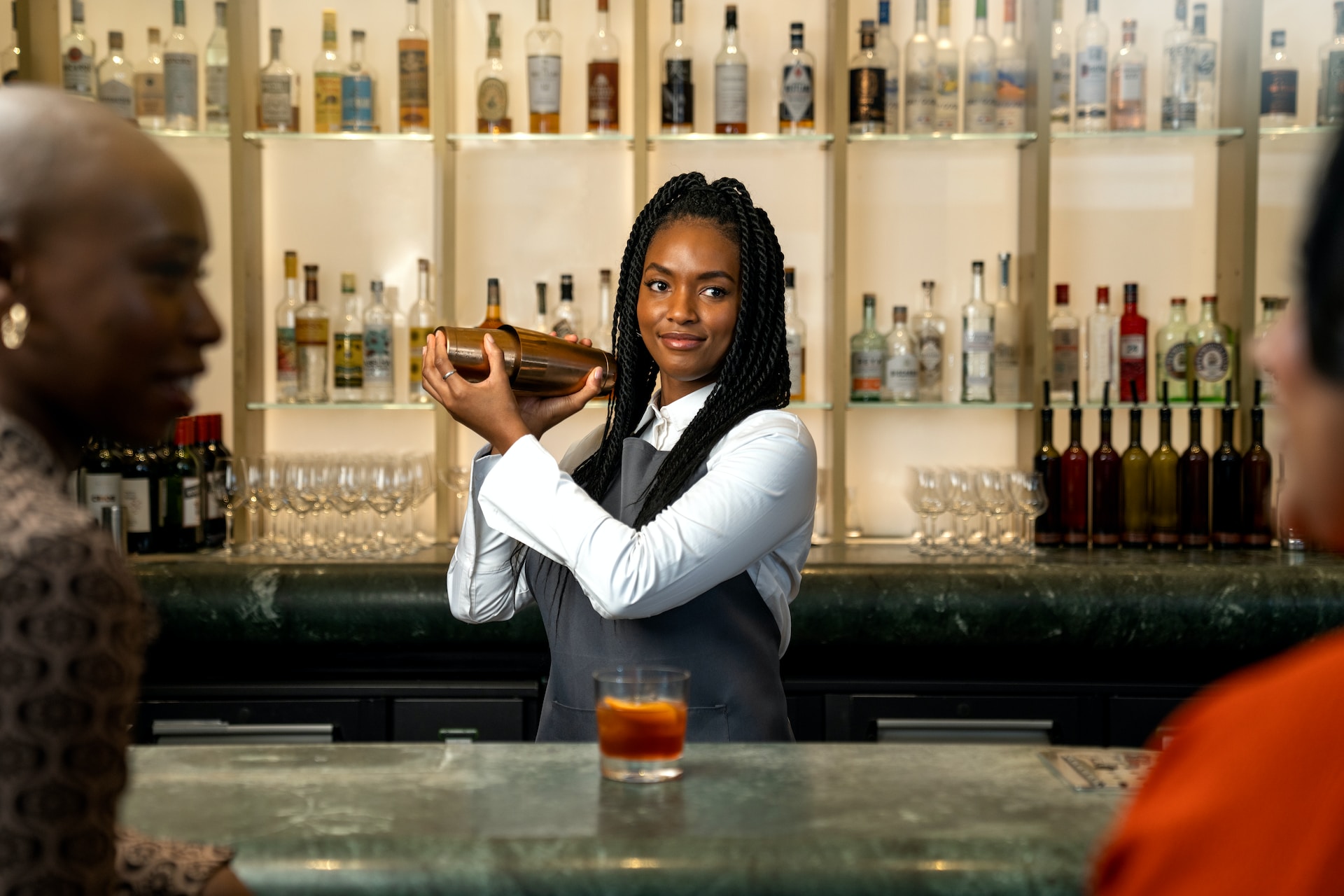 Bartender shaking a cocktail behind a bar