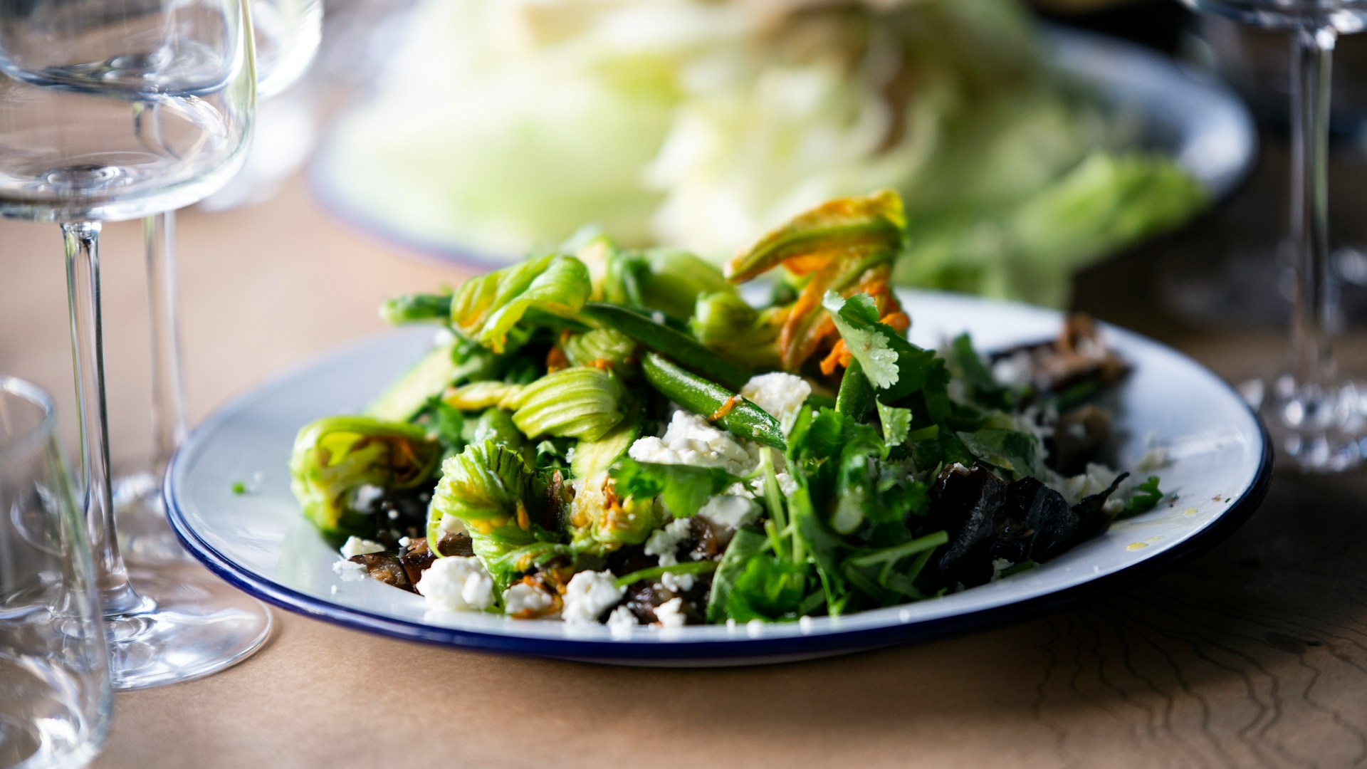 A plate of healthy green salad on a wooden table