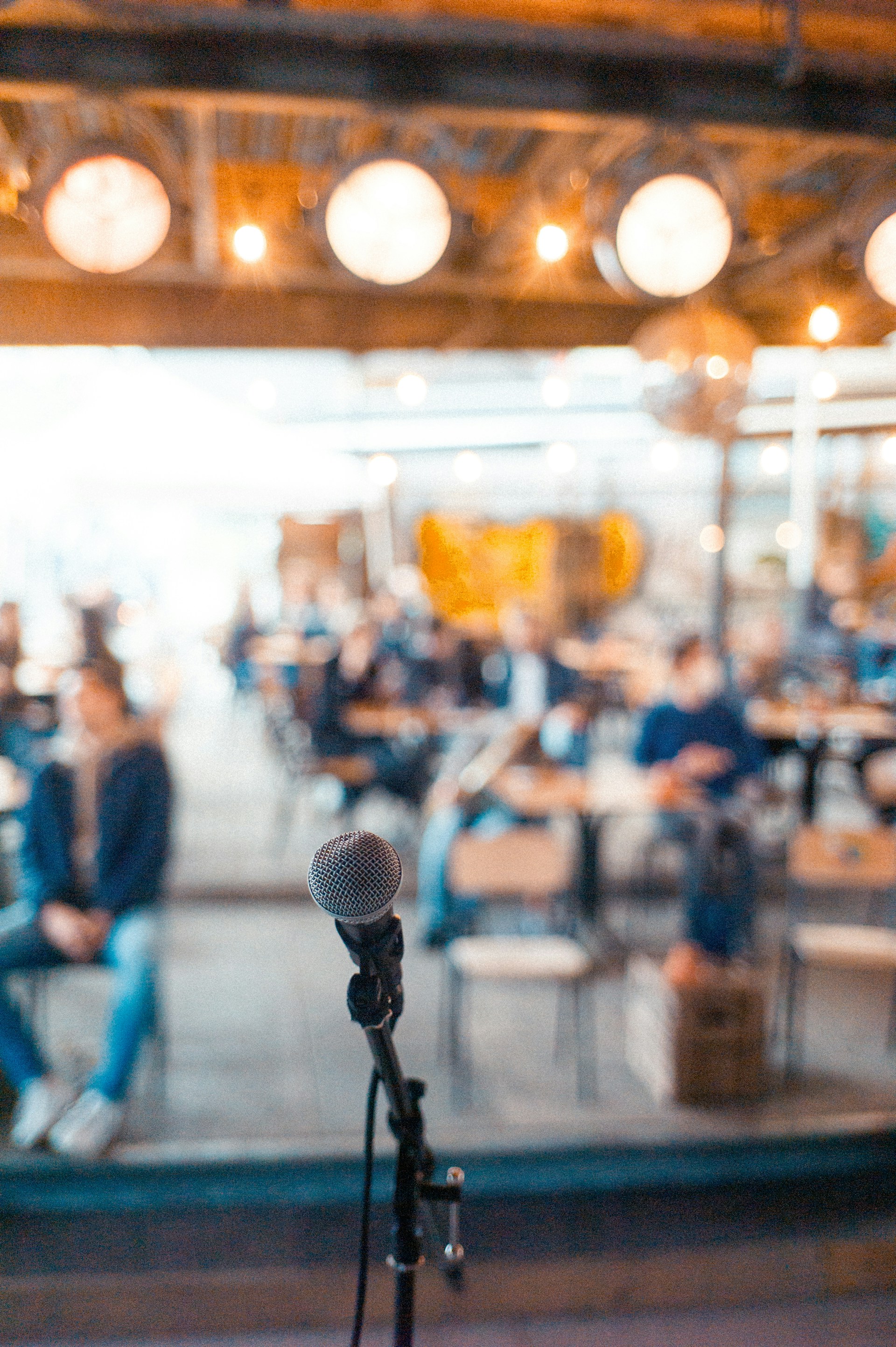Microphone in front of bright room with people