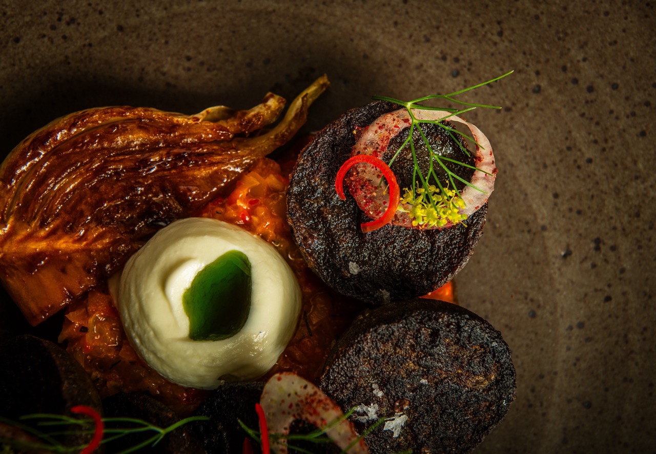 Overhead shot of beautiful plant-based food on a dark plate