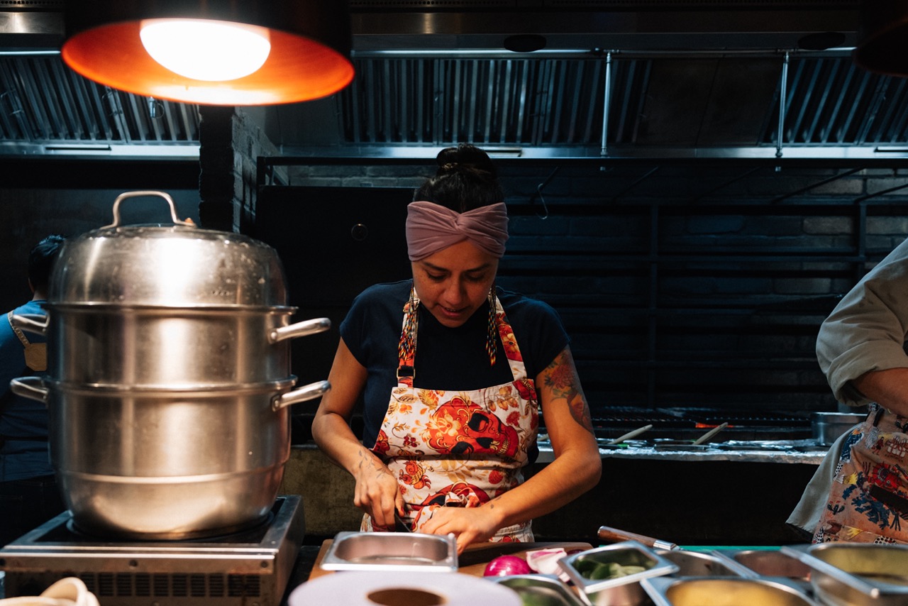Chef Adriana Cavita cooking in kitchen