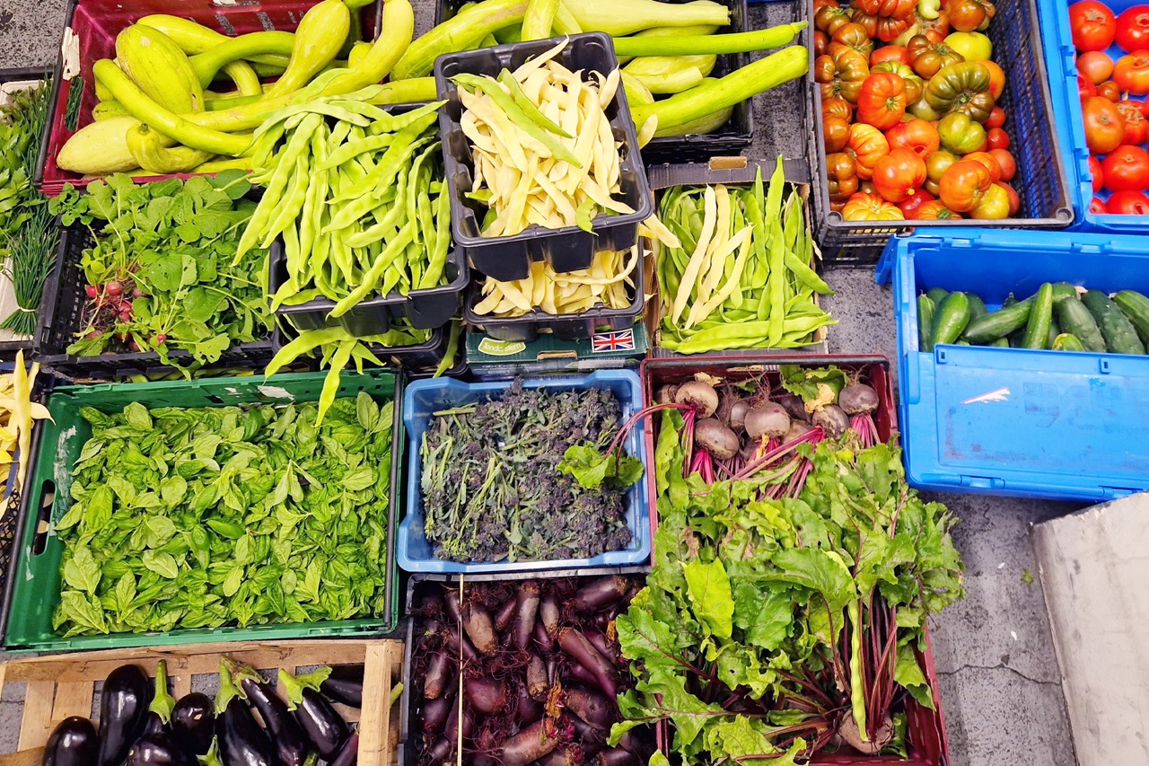 Crates of fresh fruits and vegetables shot from overhead