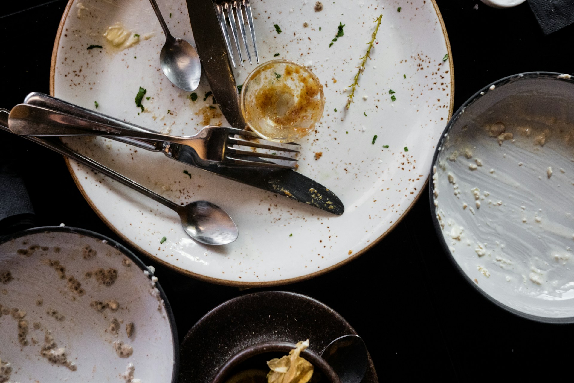 Dirty plates and cutlery shot from overhead