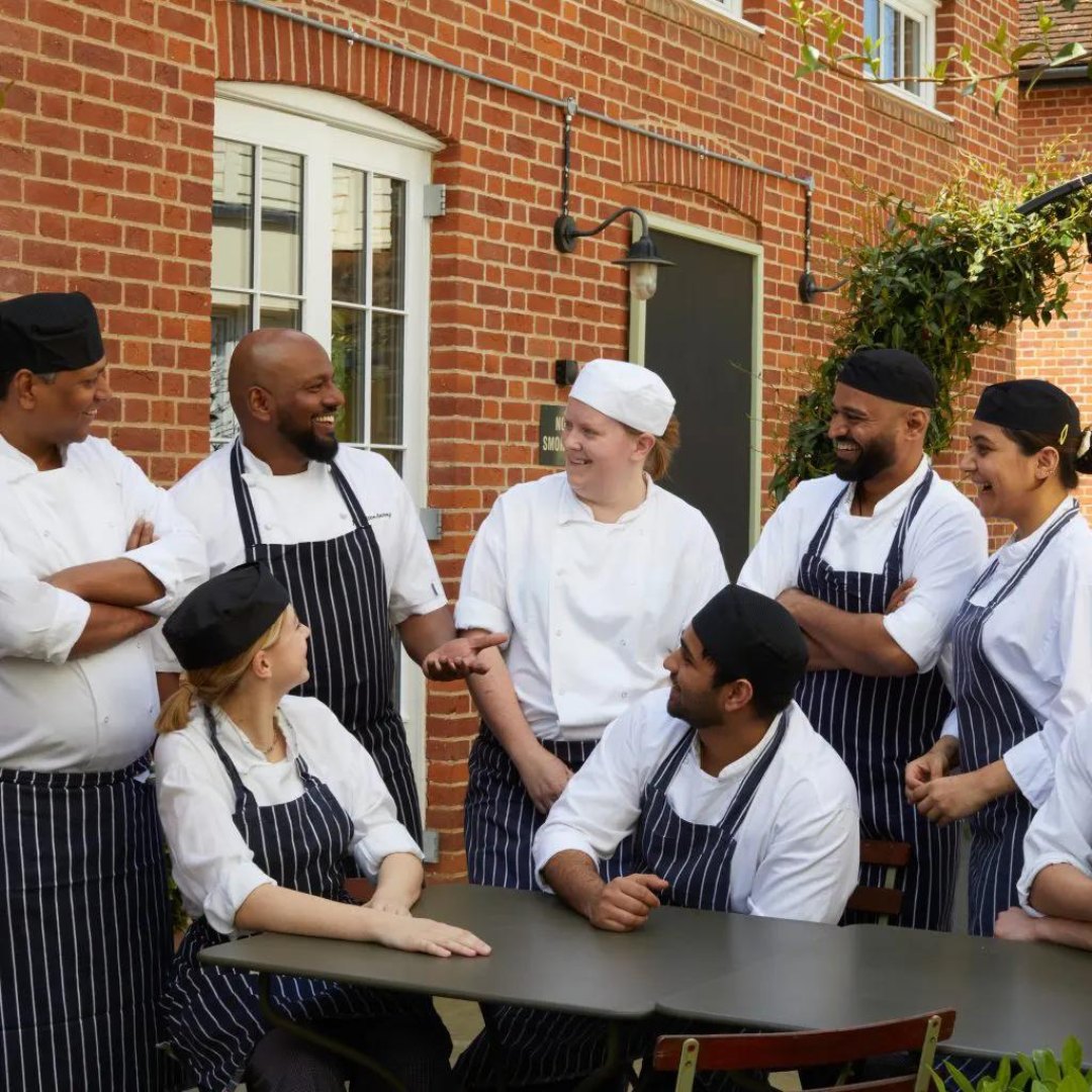 Chefs talking at table outside Heartwood Collection