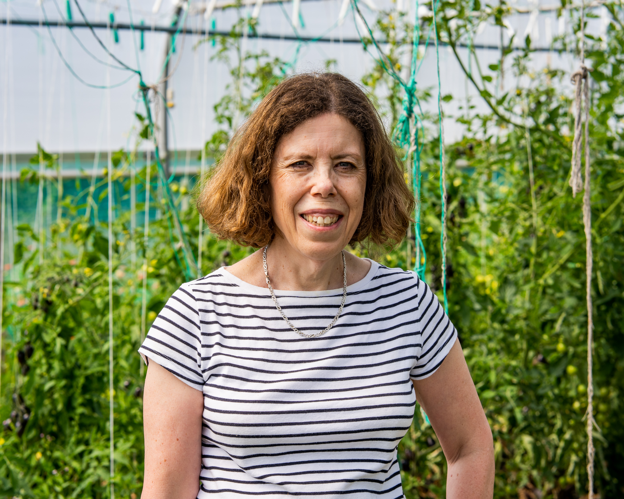 Jackie Freeman headshot against leafy background