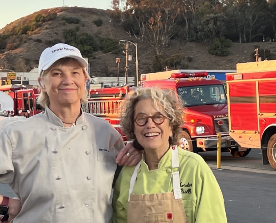 WCK Chef Corps Chefs Mary Sue Milliken and Susan Feniger with fire trucks in background