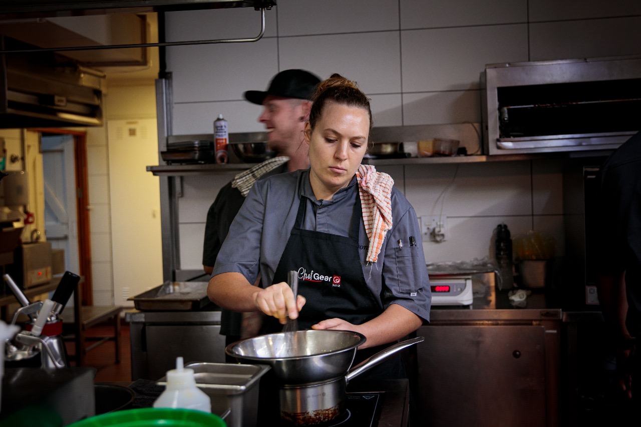 Zante Neethling of Beyond restaurant cooking in kitchen