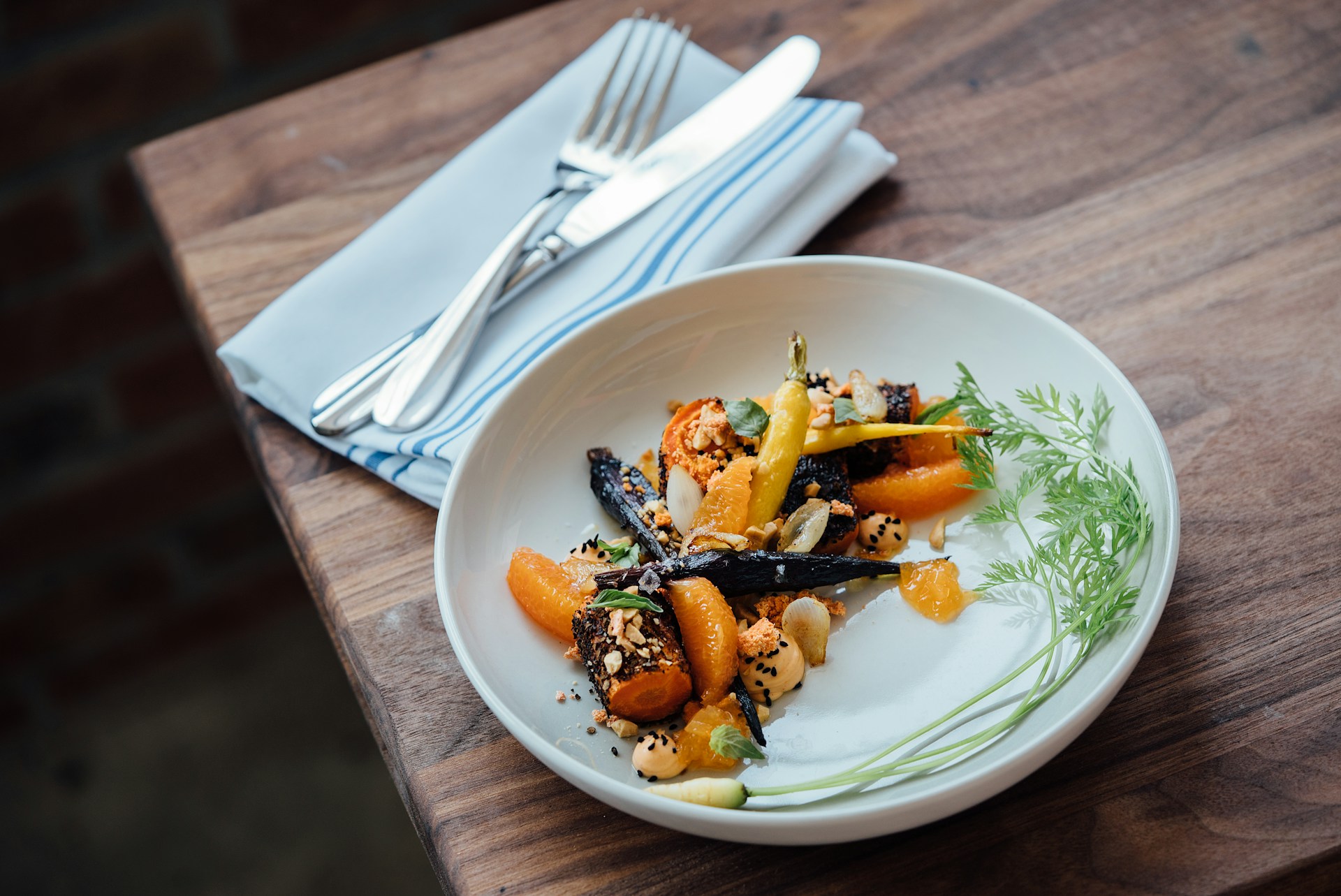 Roasted root vegetables arranged beautifully on white plate