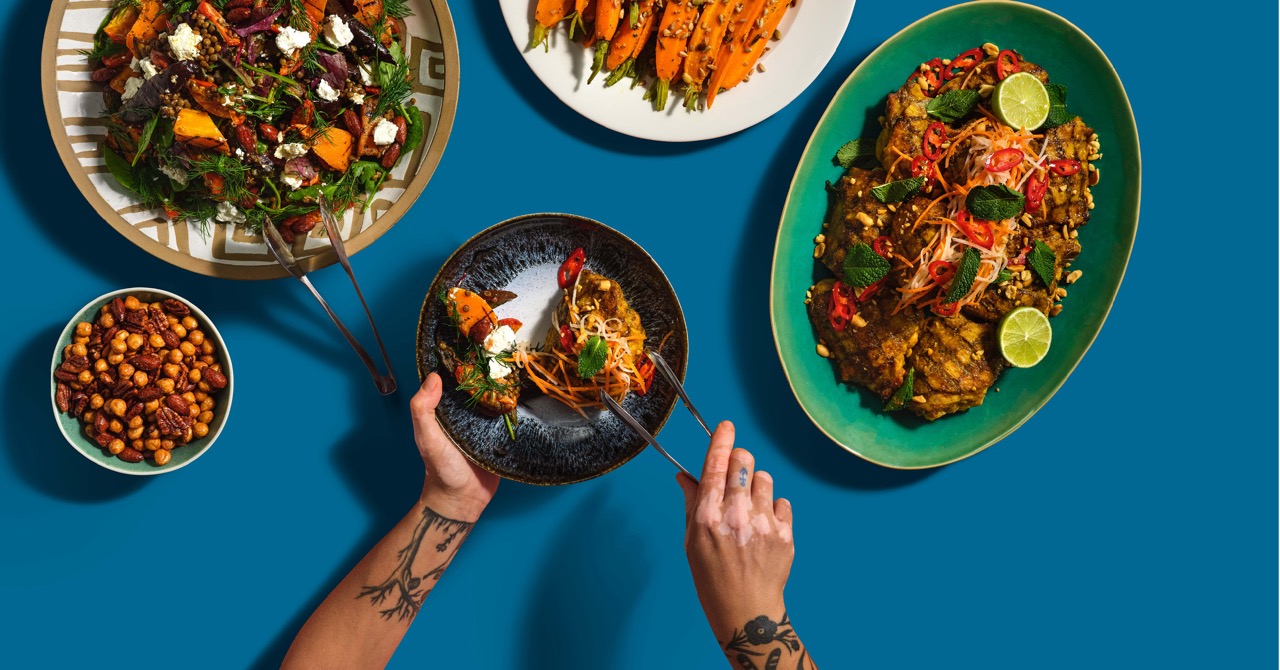 Overhead shot of food at Fooditude against blue background
