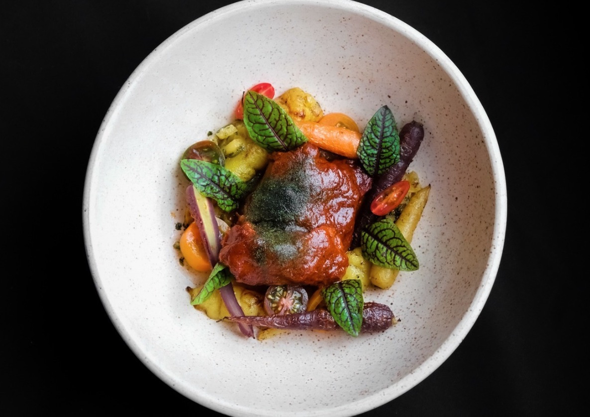 Overhead shot of beautiful food in white bowl against black surface